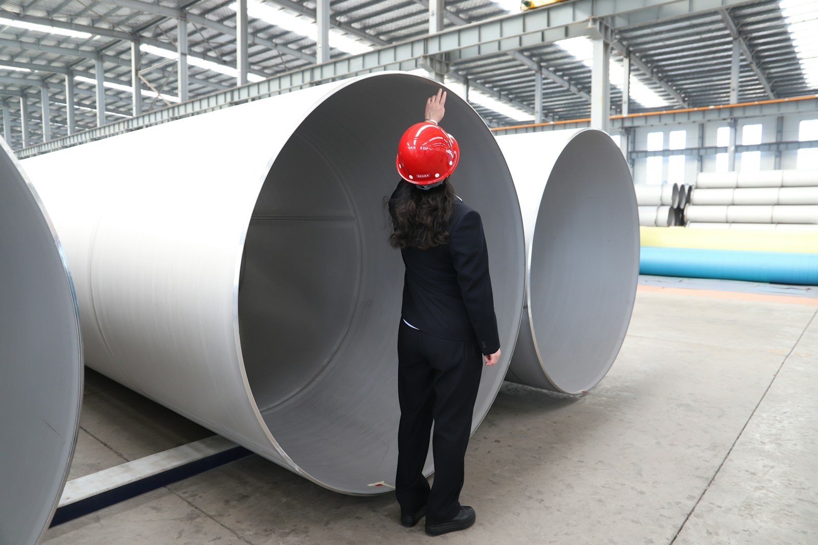Large-diameter steel pipe sections in an industrial facility — illustrative stock photo